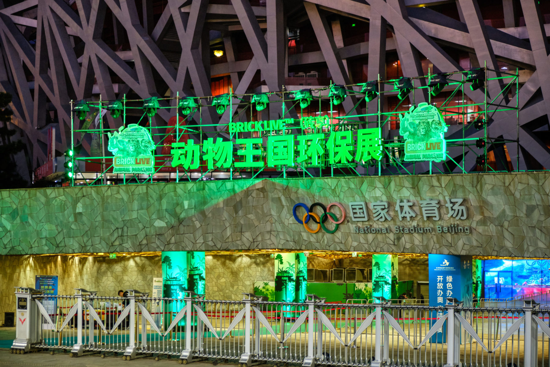 Une entrée du Stade national de Pékin, surmontée d'une grosse enseigne verte.