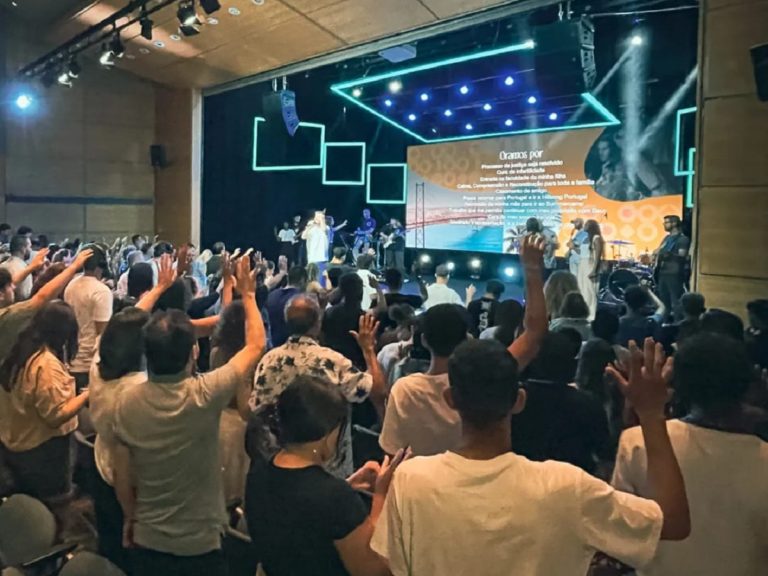 Des chrétiens debouts les mains vers le ciel chantent pour Dieu