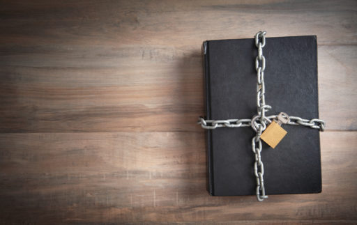 Un livre est fermé par une chaîne avec un cadenas pour ne pas pouvoir y accéder