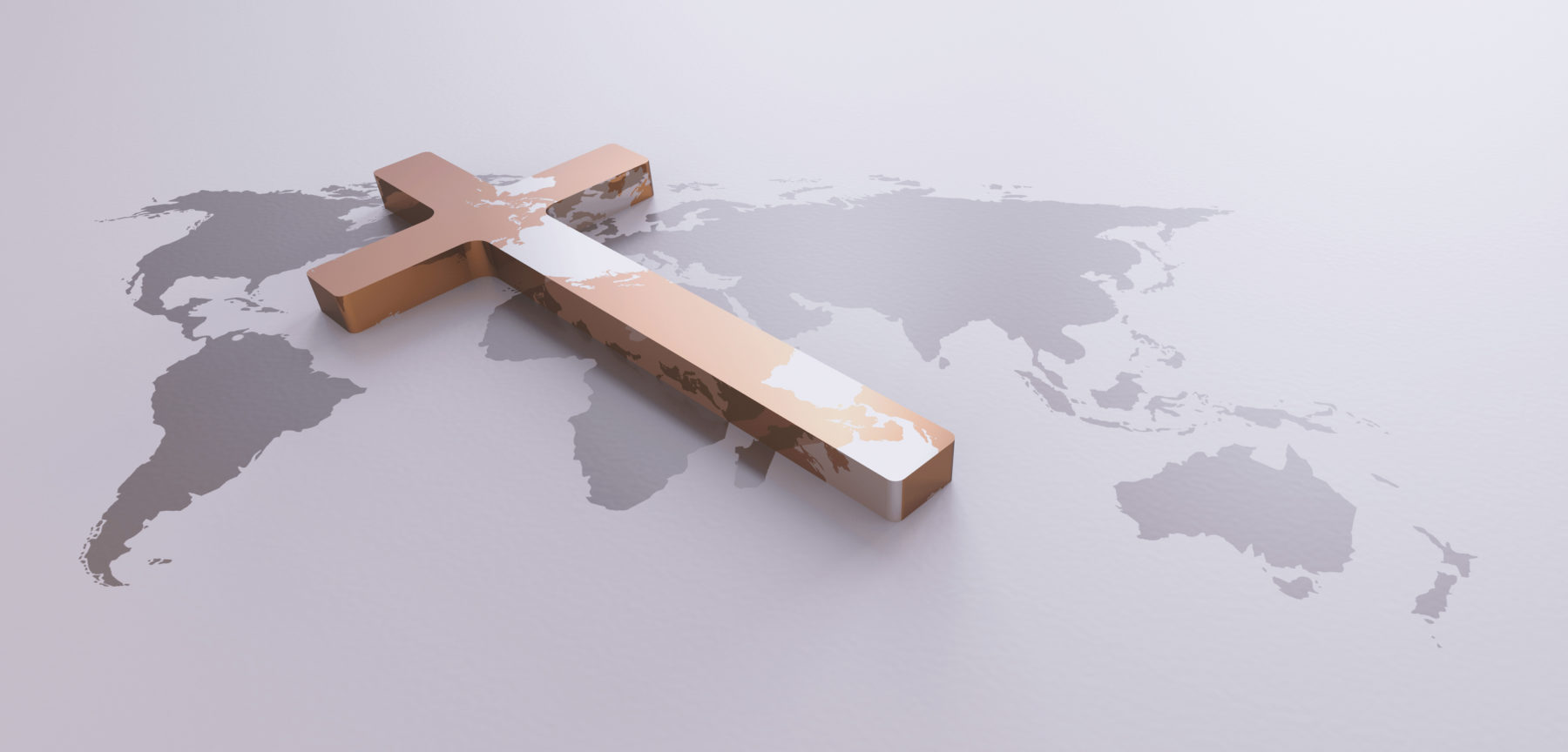 Une croix en bois recouvre une partie d'une carte du monde