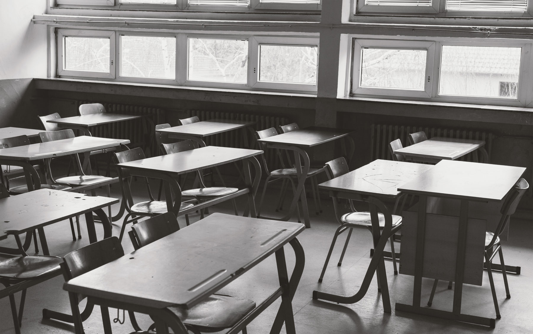 Photo en noir et blanc d'une salle de classe vide